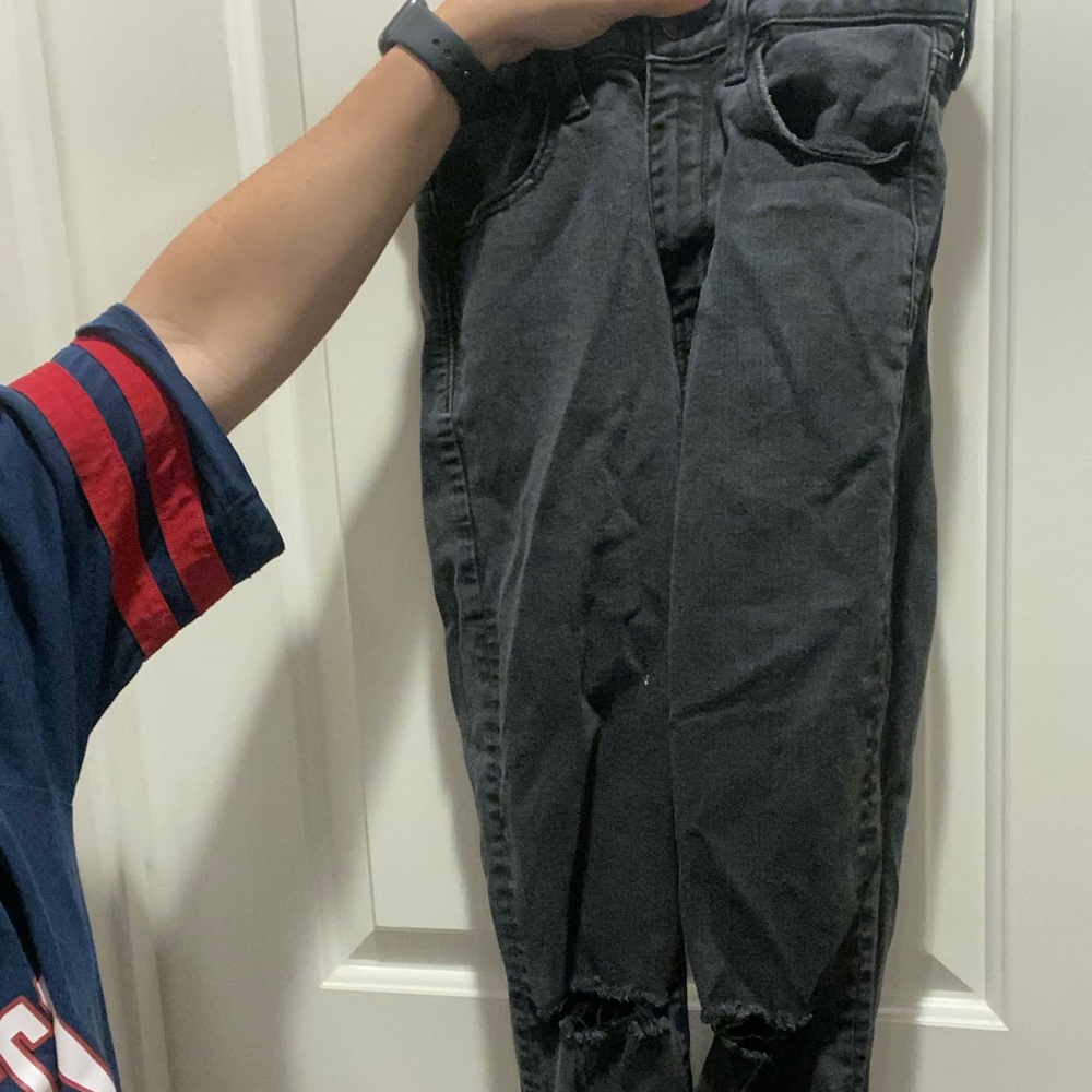 High waisted black washed jeans. Rips in knee